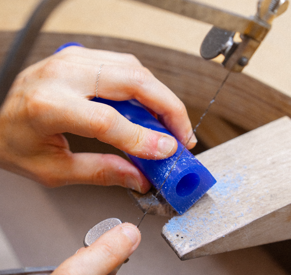 Hand working with blue wax 