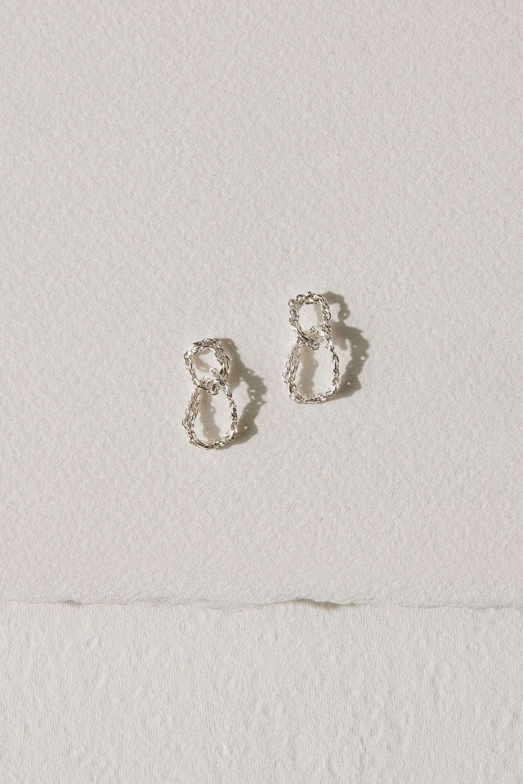 Silver drop earrings with two interlocking circles by Camillette Jewelry