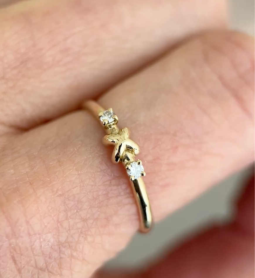 Gold ring with diamonds on a finger